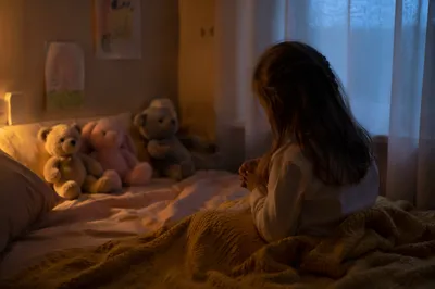 Child Praying Beside Bed in Nightlight