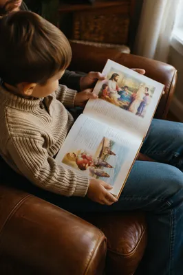 Child Reading Picture Bible on Parent's Lap