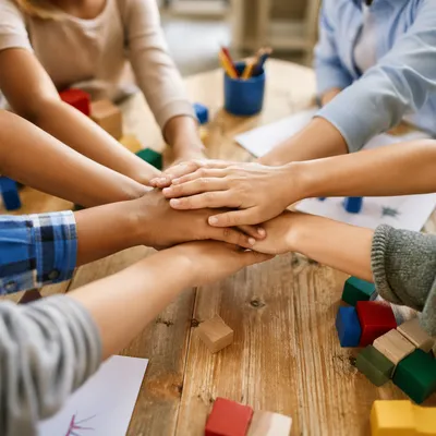Children Hands Stacking in Teamwork Circle