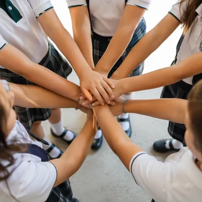 Children Stacking Hands in School Teamwork