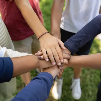 Children Stacking Hands in Teamwork Fellowship