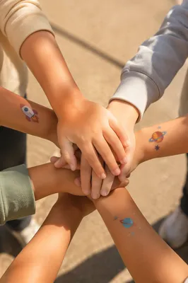 Children Hands Stacked in Sunny Teamwork