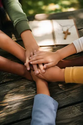 Children Stacking Hands After Church Activity
