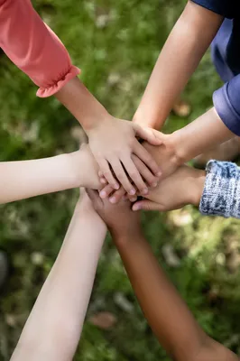 Children Hands Stacked in Cheerful Teamwork