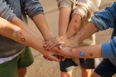 Children Stacking Hands in Teamwork