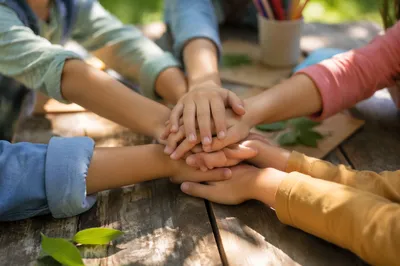 Children Hands Stacked in Garden Teamwork
