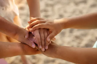 Children’s Hands United on Sandy Beach
