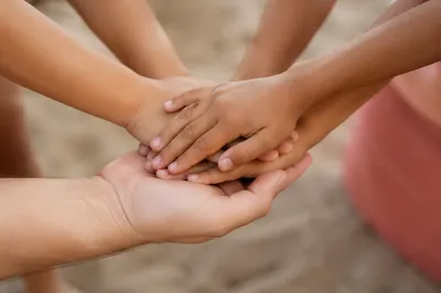 Children Hands Stacked in Gentle Teamwork