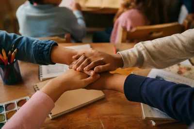Children Hands Stacked in Faith Classroom