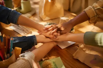 Children Stacking Hands for Teamwork Service