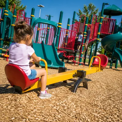 Children Playing at Sunny Colorful Playground