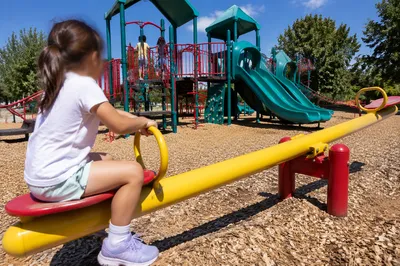 Children Playing at Sunny Colorful Playground