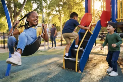 Children Playing on Sunny Neighborhood Playground
