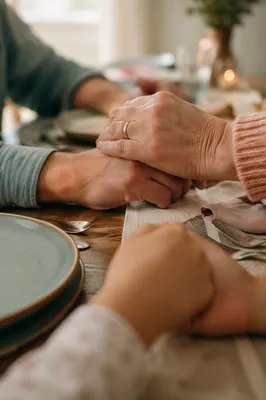 Christian Family Hands Joined in Dinner Prayer