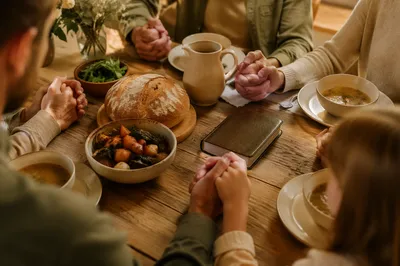 Christian Family Dinner Prayer Around Wooden Table