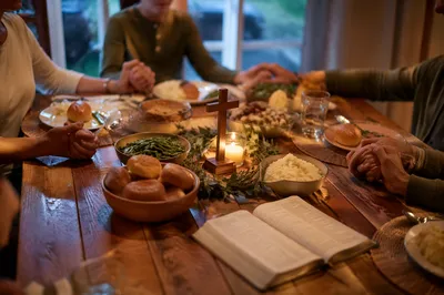 Christian Family Dinner Prayer Around Wooden Table