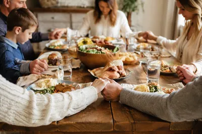 Christian Family Dinner Prayer at Rustic Table
