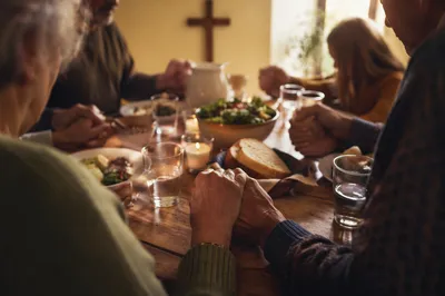 Christian Family Dinner Prayer Around Rustic Table