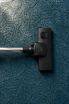Vacuum Cleaner on Teal Carpet