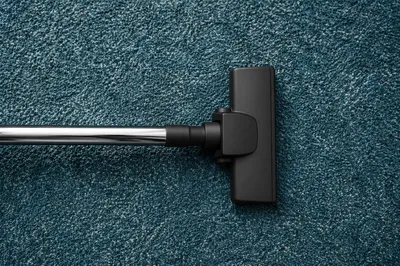 Vacuum Cleaner on Teal Carpet