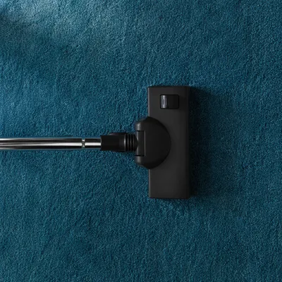 Vacuum Cleaner on Teal Carpet