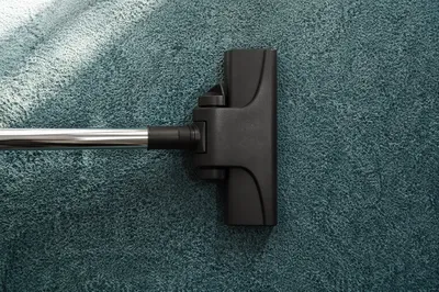 Vacuum Cleaner on Teal Carpet