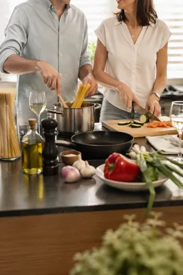 Couple Cooking Pasta in Modern Kitchen