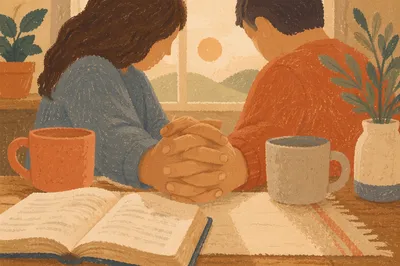 Couple Praying Hand in Hand at Table