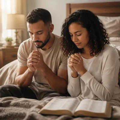 Young Couple Praying in Sunlit Bedroom