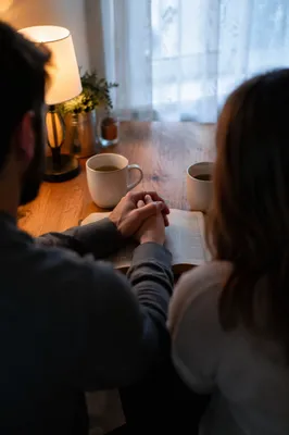 Couple Praying Together at Dawn Kitchen Table