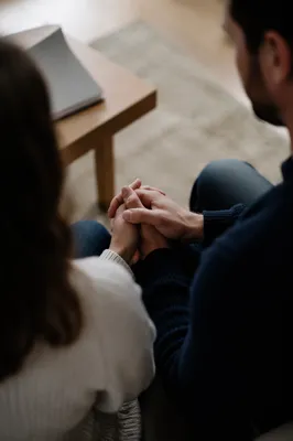 Couple Praying Together Holding Hands