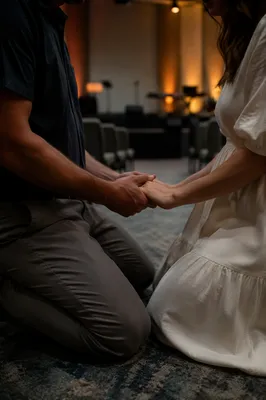 Couple Praying Hand in Hand at Church