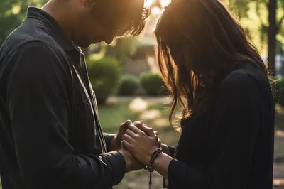 Couple Praying Hand in Hand in Garden