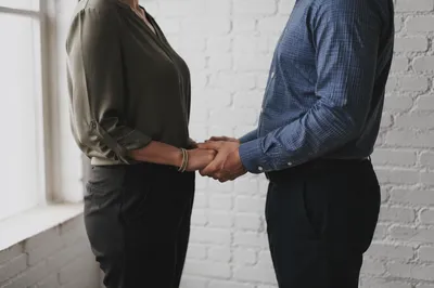 Couple Holding Hands in Quiet Prayer