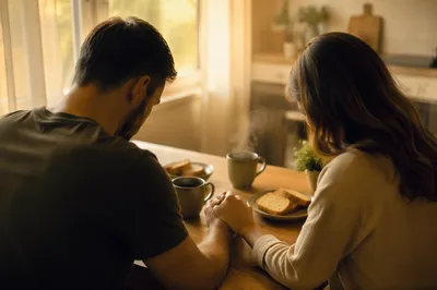 Couple Praying Together at Sunrise Table