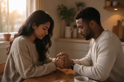 Young Couple Praying at Kitchen Table