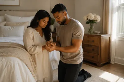 Young Couple Praying Beside Bed