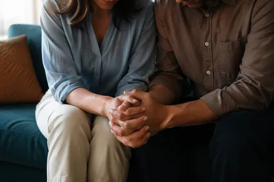 Couple Praying Together on Teal Sofa