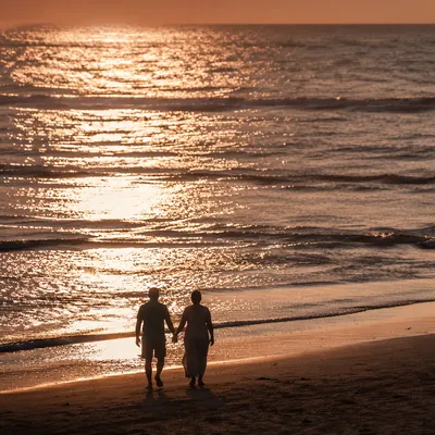 Couple Silhouette Walking on Sunset Beach