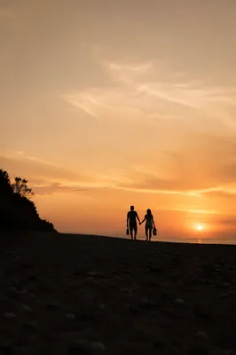 Couple Holding Hands on Sunset Beach