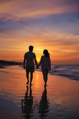 Couple Walking Hand in Hand at Sunset