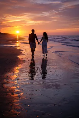 Couple Walking on Beach at Sunset