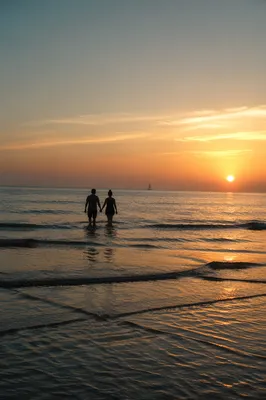 Couple Walking Hand in Hand at Sunset