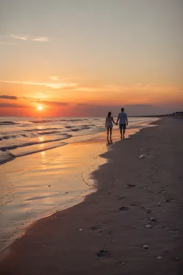 Couple Walking Hand in Hand at Sunset