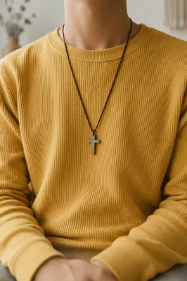 Cross Pendant on Mustard Knit Sweatshirt