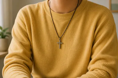 Cross Pendant on Mustard Knit Sweatshirt
