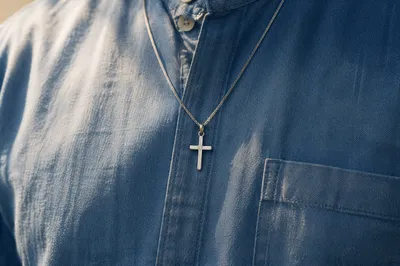 Silver Cross Pendant on Denim Shirt