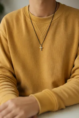 Cross Necklace on Mustard Knit Sweatshirt