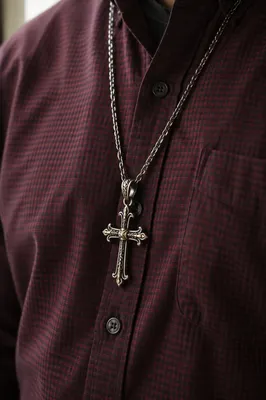 Silver Cross Necklace on Burgundy Shirt