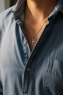 Silver Cross Pendant on Denim Shirt